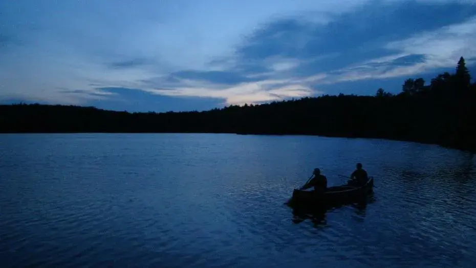 background image of 2 people in a canoe